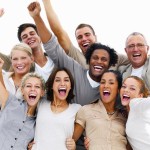 Portrait of a group of business people laughing against white ba